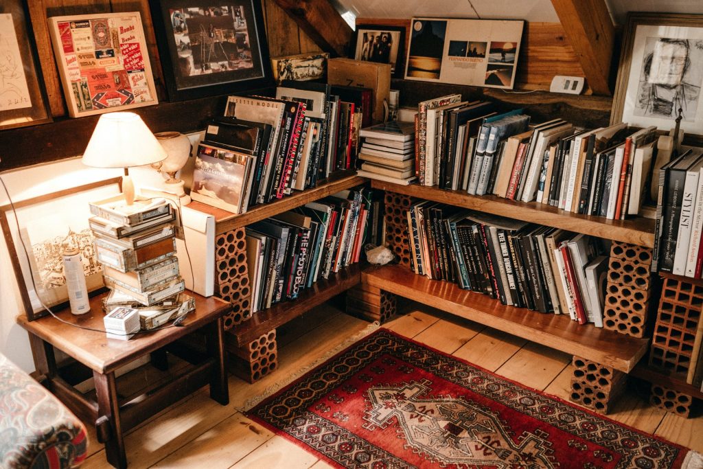 <alt text: Books, paintings and documents in a home library.>