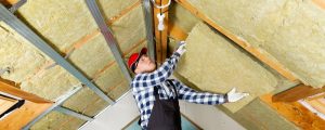 Man placing insulation into the attic
