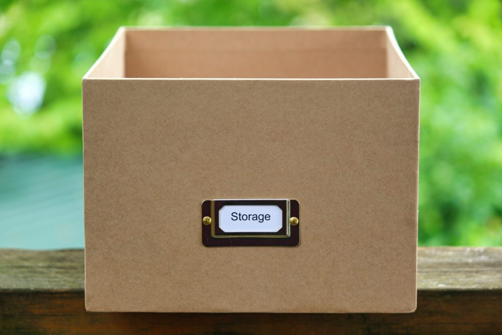  A sturdy cardboard box labelled “storage” will be used in a short term storage unit.