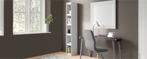 Tall narrow bookcase in a small home office