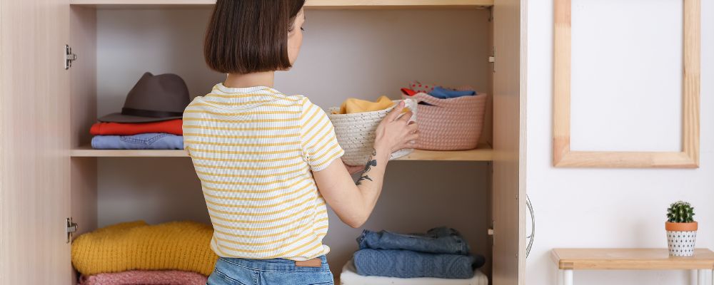 Neatly organised clothes in a closet